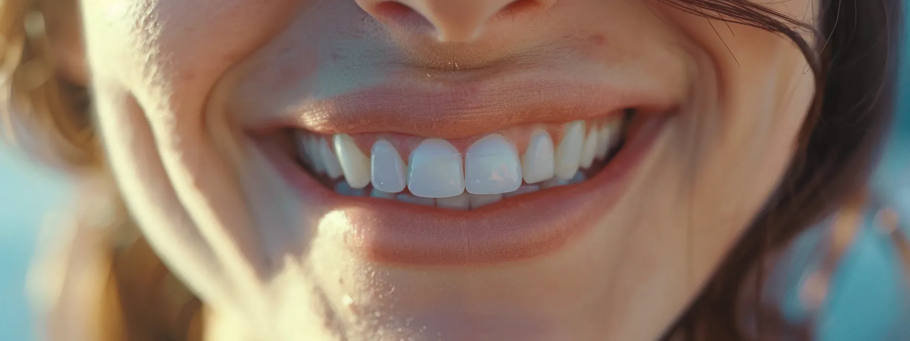 a close-up of a smiling individual confidently displaying their ceramic braces, blending seamlessly with their teeth, creating a subtle and aesthetically pleasing orthodontic option.