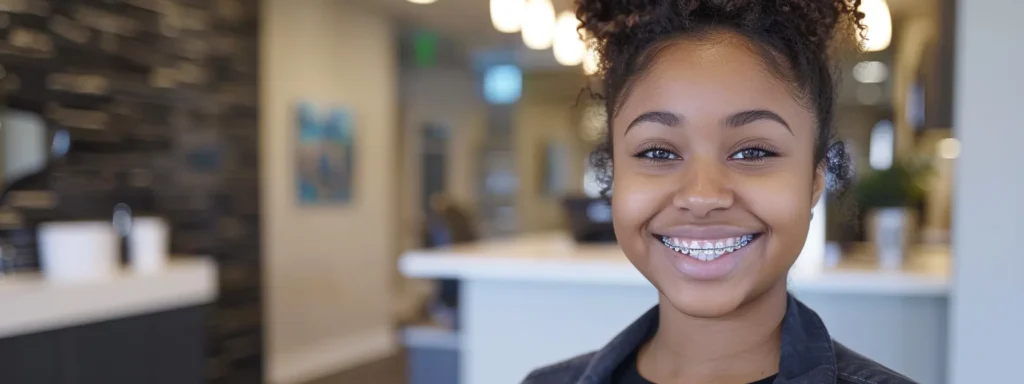 a smiling young woman confidently showing off her clear invisalign braces at the orthodontist's office.